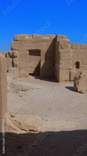Seti I mortuary temple exterior with Osiride colonnade and palm trees in Luxor