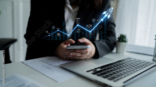 Photos Business professional using smartphone while analyzing data trends with growth p