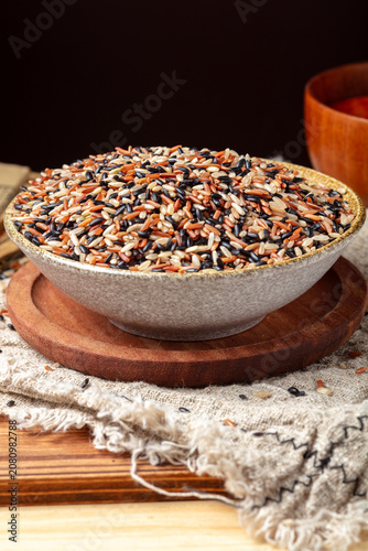 Bowl of Mixed Rice Grains on Wooden Board