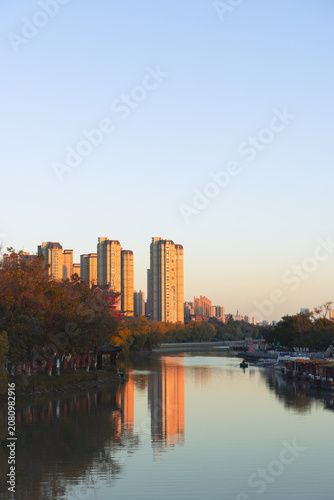 City Canal with Sunset Reflections and High-Rise Buildings