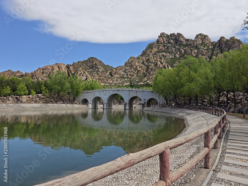 Mountain Lake with Stone Arch Bridge in a Scenic Park