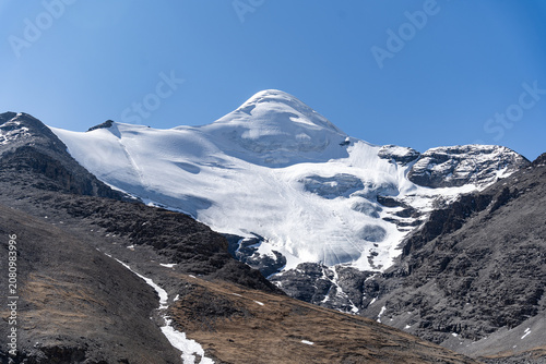Snow-Covered Mountain Glacier Under Blue Sky