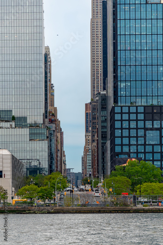 Fotografija Empire State Building visible between modern glass skyscrapers