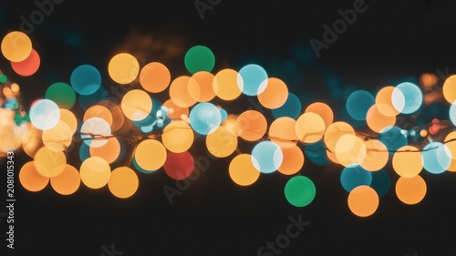 Colorful String Lights Against Black Background with Bokeh Effect at Night Time