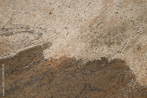 Fotografie Light beige granite texture with natural brown mineral veining and rough stone surface