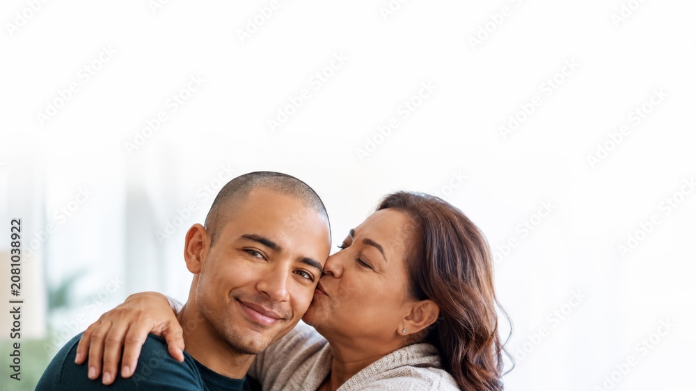 Fototapeta premium Happy mother and son embracing with genuine smiles, showcasing a strong family bond and affection