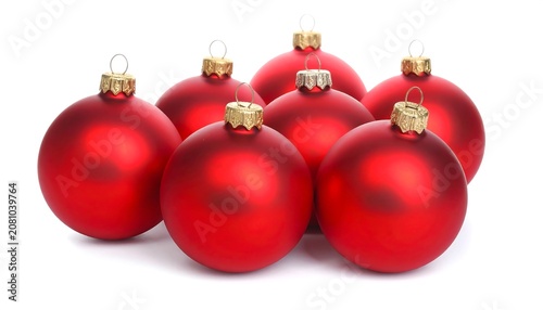 A close-up shot of seven shiny red spherical ornaments with golden caps, arranged against a bright white background