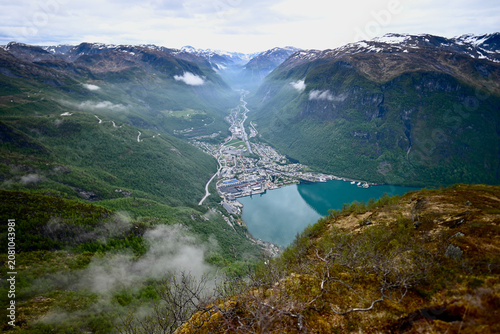 Panoramic view of Høyanger village in Norway from above the fjord, showcasing the valley, colorful settlement, and turquoise waters below.