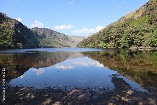 :   Picturesque mountain lake surrounded by mountains, Upper Glendalough Lake, County Wicklow, Ireland.