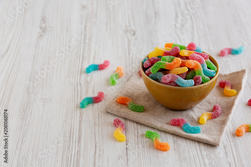 Sugary Sour Gummy Worms in a Bowl, side view. Copy space.