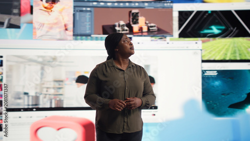 Photos Woman reacts with amazement to a digital wall filled with streaming videos and social media clips for modern entertainment