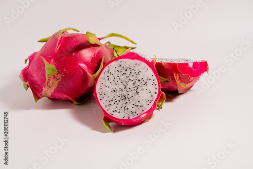 Fresh dragon fruit cut in half and whole dragon fruit isolated on a white background. perfect for healthy food and nutrition concepts.