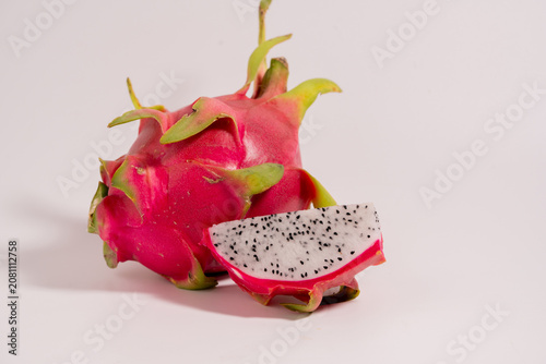 Fresh dragon fruit cut in half and whole dragon fruit isolated on a white background. perfect for healthy food and nutrition concepts.