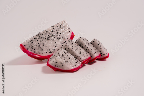 Fresh dragon fruit cut in half and whole dragon fruit isolated on a white background. perfect for healthy food and nutrition concepts.
