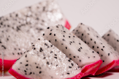 Fresh dragon fruit cut in half and whole dragon fruit isolated on a white background. perfect for healthy food and nutrition concepts.