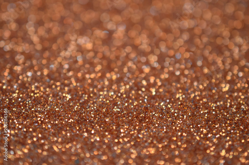 Bronze glitter texture background with shallow depth of field bokeh