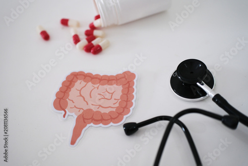 Obraz na plátne A stethoscope, a symbol of the colon, and pills coming out of a bottle