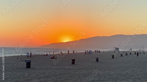 Slow motion of the orange sunset on the beach

