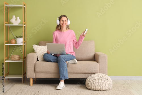 Young woman with laptop and...