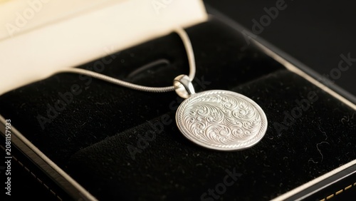Oval filigree pendant necklace in velvet jewelry box, luxurious accessory