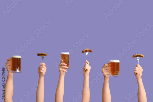 Hands with glasses of beer ...