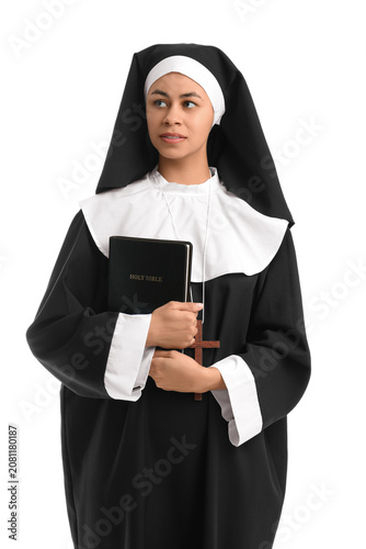 Bild auf Leinwand Portrait of young nun with Bible on white background