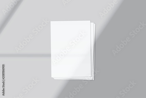 Blank white A4 paper sheets mockup on background with elegant organic shadow overlay. Perfect for displaying stationery designs, flyers, posters, branding, Ads and print design presentations