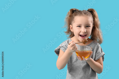 Cute little girl holding bo...