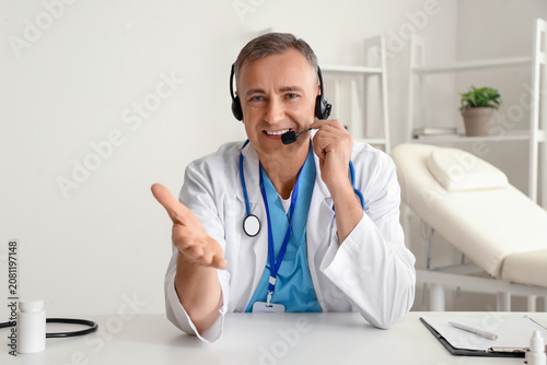 Mature doctor in headset vi...