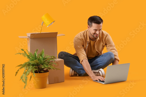 Young man with moving boxes...