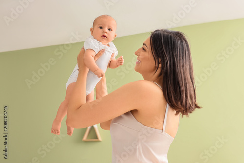 Happy mother with cute litt...