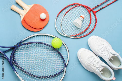Tennis paddle rackets with ball on grey background. Summer sport activity concept. Top view