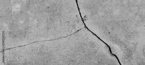 Cracked gray concrete surface texture with weathered cement pattern