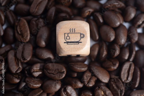 White coffee cup on roasted coffee beans representing coffee break and hot beverage