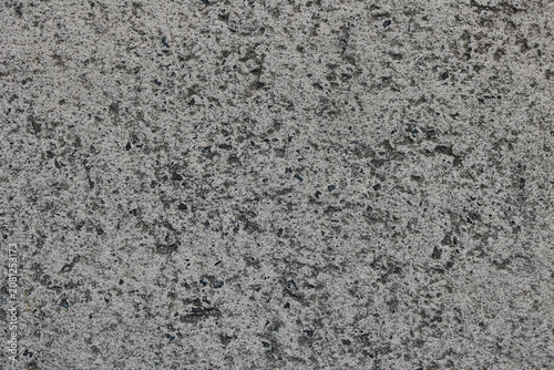 Fotografie The weathered and pitted surface of an old concrete or asphalt slab