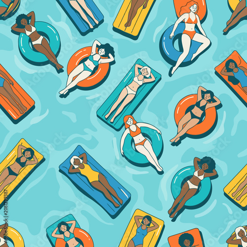Diverse women relaxing on colorful pool floats in blue water