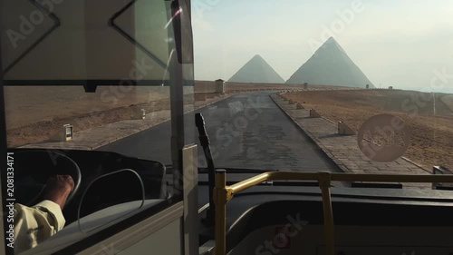 View from driving modern shuttle bus toward the Giza Pyramids highlighting new transport infrastructure