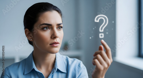 Thoughtful Businesswoman Looking at a Floating Question Mark Icon 