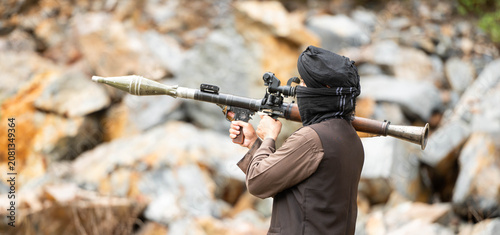 Photos Armed militant aiming a rocket launcher during a simulated conflict scenario in