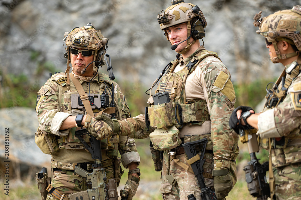Fototapeta premium Military personnel communicate and coordinate during a field operation briefing