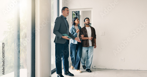 Couple, relocation and tour with realtor in new home for opportunity, sale or viewing. People, mortgage loan and property buyer with bond in real estate space for development, inspection or purchase