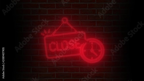 Red neon sign 'Closed' with clock on brick wall at night