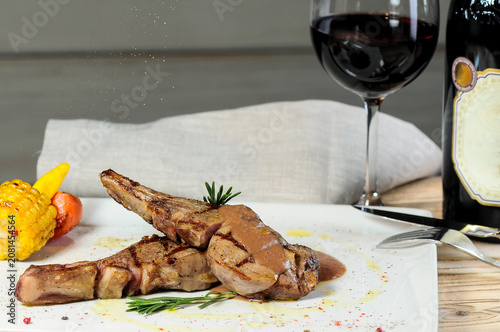 Grilled Lamb Chops with Corn and Tomato on Dining Table