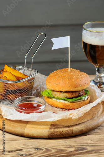 Burger with Fries and Beer on Wooden Table