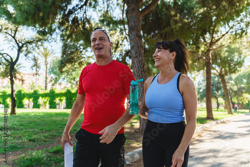 Fotografia Senior couple walking together in a park after exercising, staying active and he