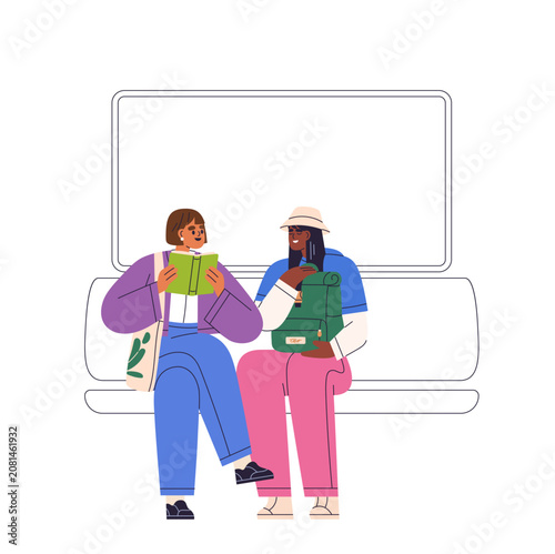 Women sitting in subway car, chatting. Commuters in public transport with bag...