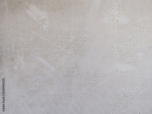Abstract photo of wall texture with scratches and marks in beige tones. Perfect for vintage, industrial, and creative background themes.