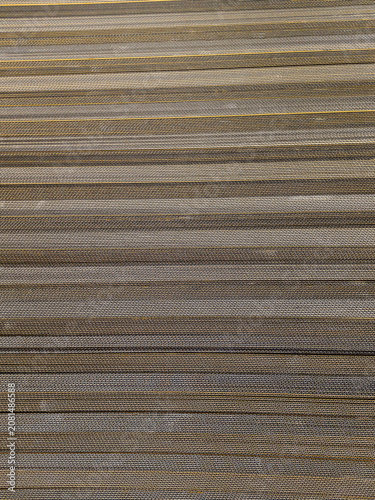 Abstract photo of stacked cardboard edges in vertical lines with brown, beige, and gray tones. Perfect for texture, design, and modern background themes.