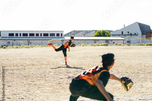 Φωτογραφία Young baseball pitcher throwing a fastball to the catcher in a little league gam