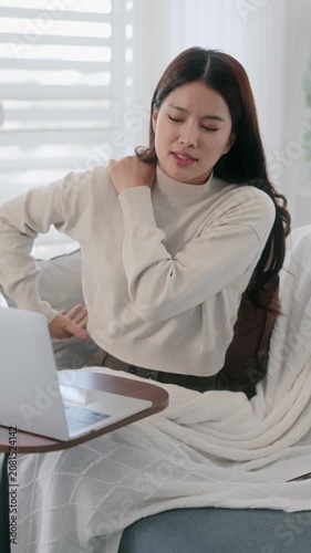Asian woman using laptop for video conference with doctor at home, telemedicine